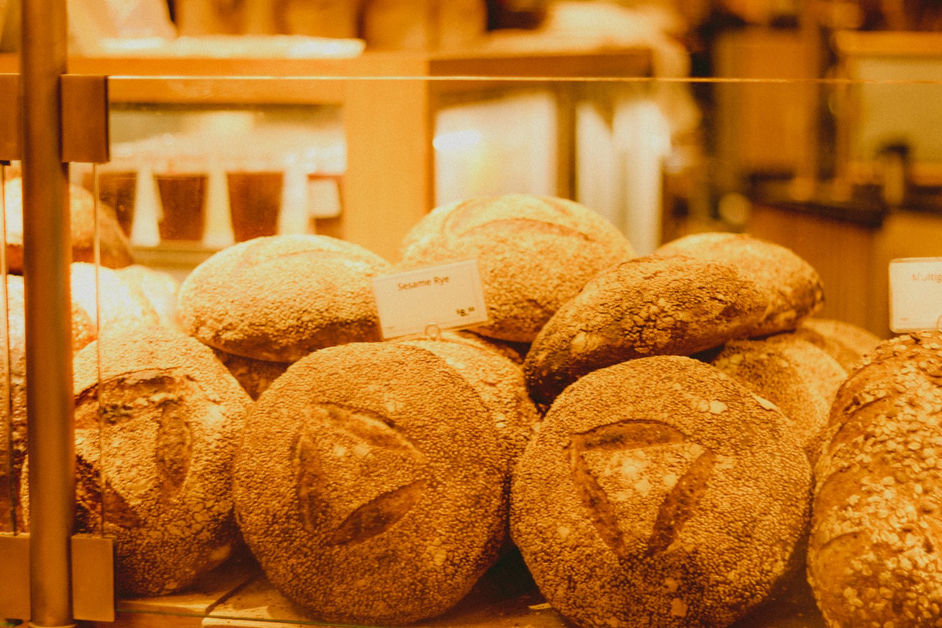 A display of fresh breads and pastries in a bakery setting, highlighting variety and texture.